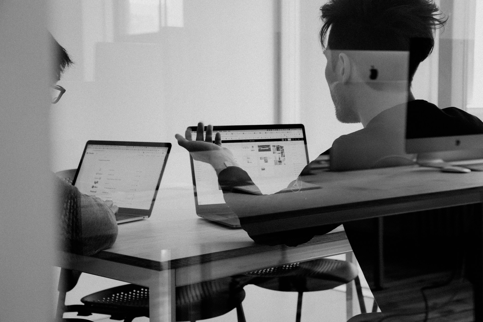 MMK team reviewing evidence and documents in editorial black and white.