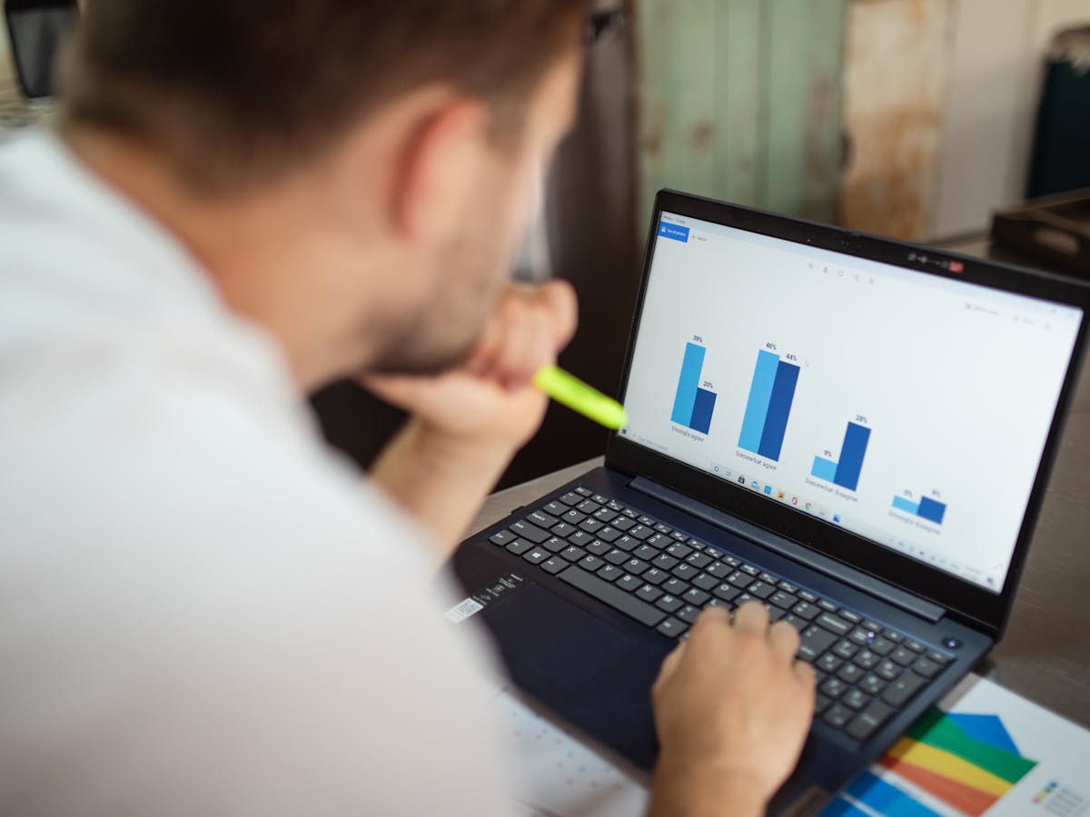 Analyst reviewing data and market evidence on a laptop dashboard.