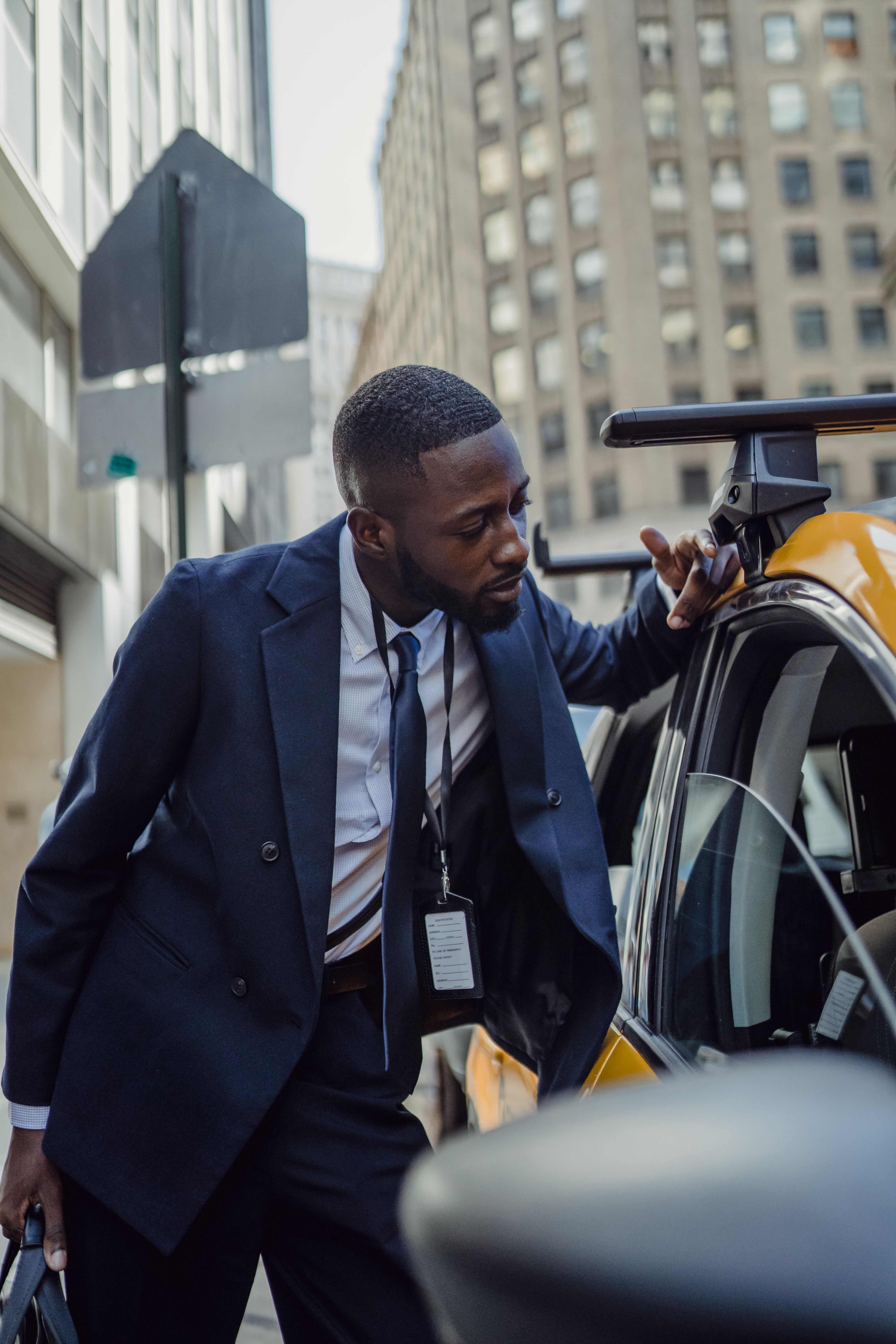 African business professional in formal attire preparing for a finance meeting in an urban setting.