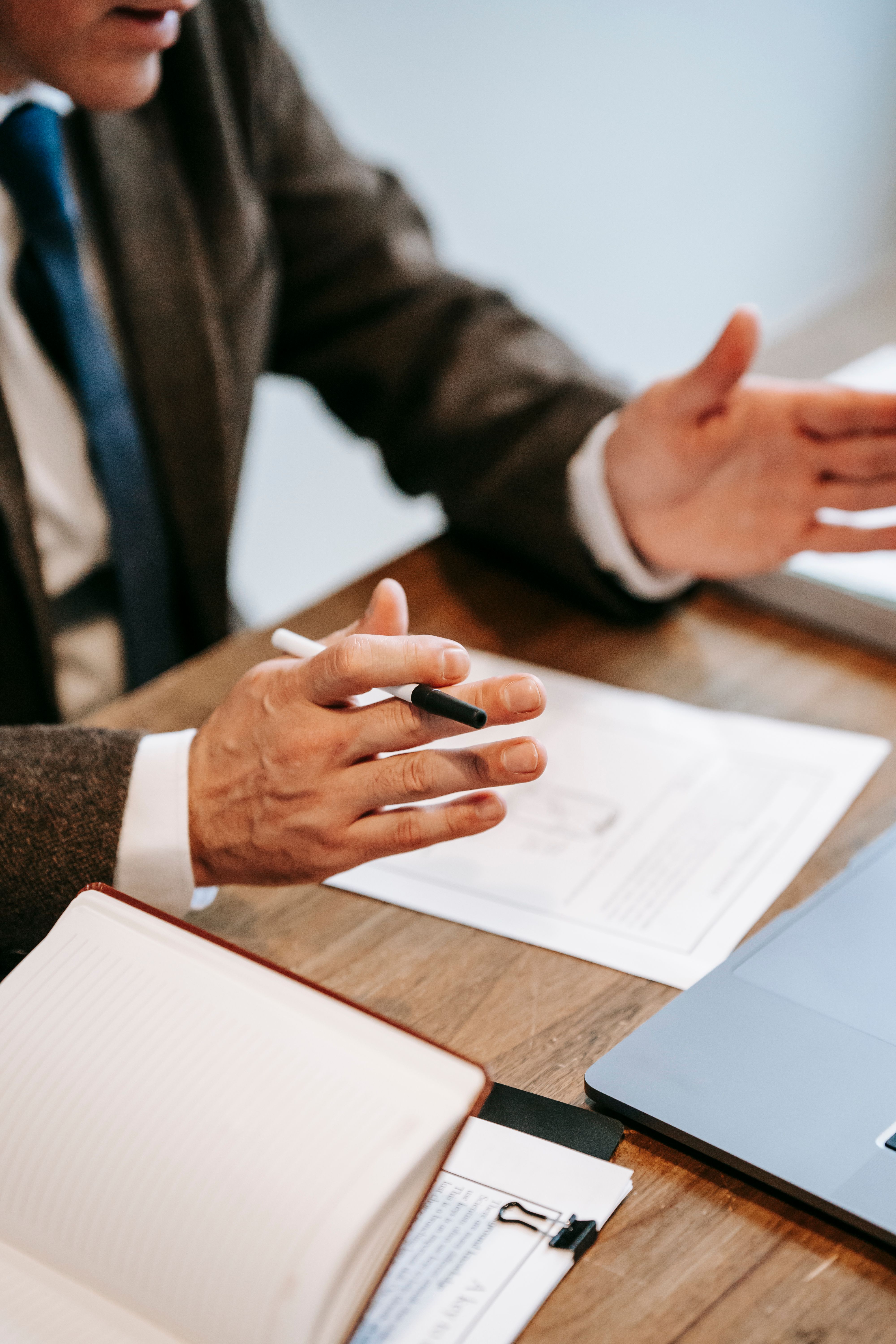 Business professionals reviewing financial documents and investment plans during a meeting.